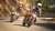 Friends riding a motorcycle round a bend