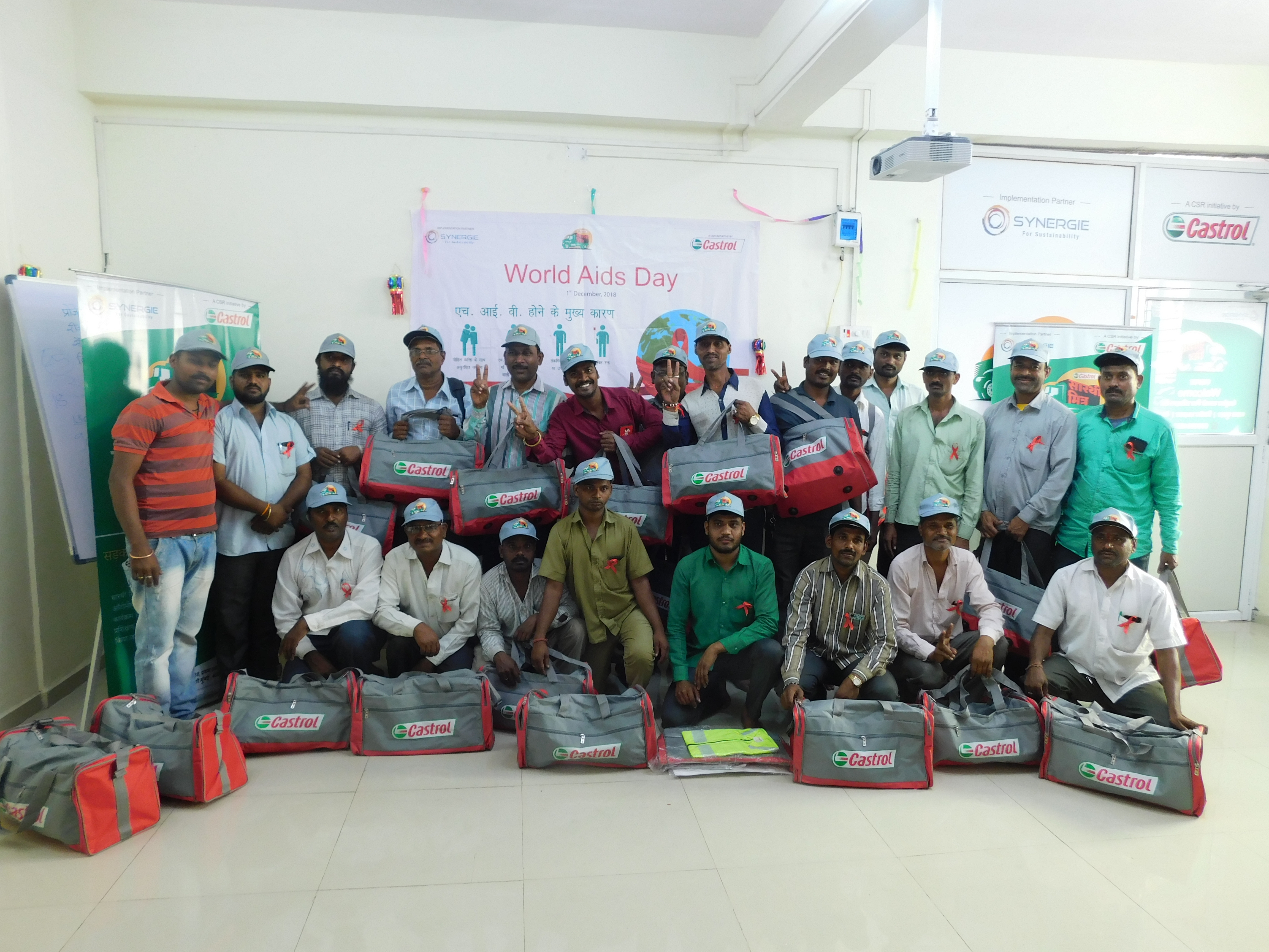 22 Male workers with grey Castrol bags.
