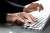 woman's hand typing on a laptop keyboard