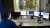 Man in front of four computer screens